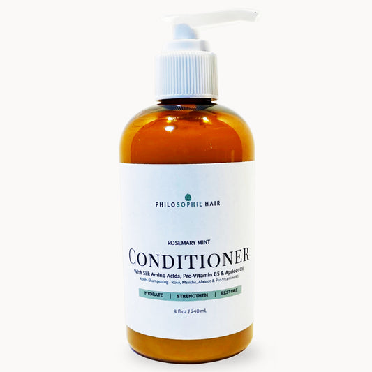 Bottle of Philosophy Hair Rosemary Mint Conditioner on a white background