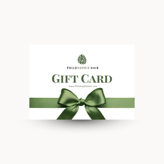 Philosophie Hair gift card with a green ribbon on a white background