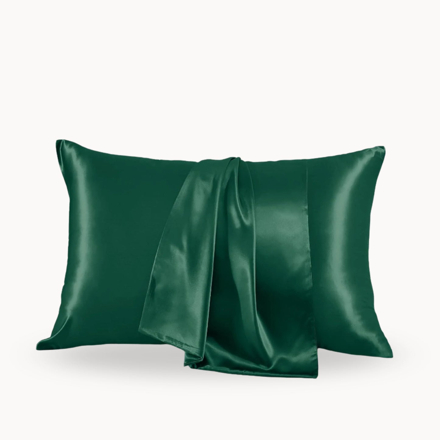 Two green satin pillowcases on a white background