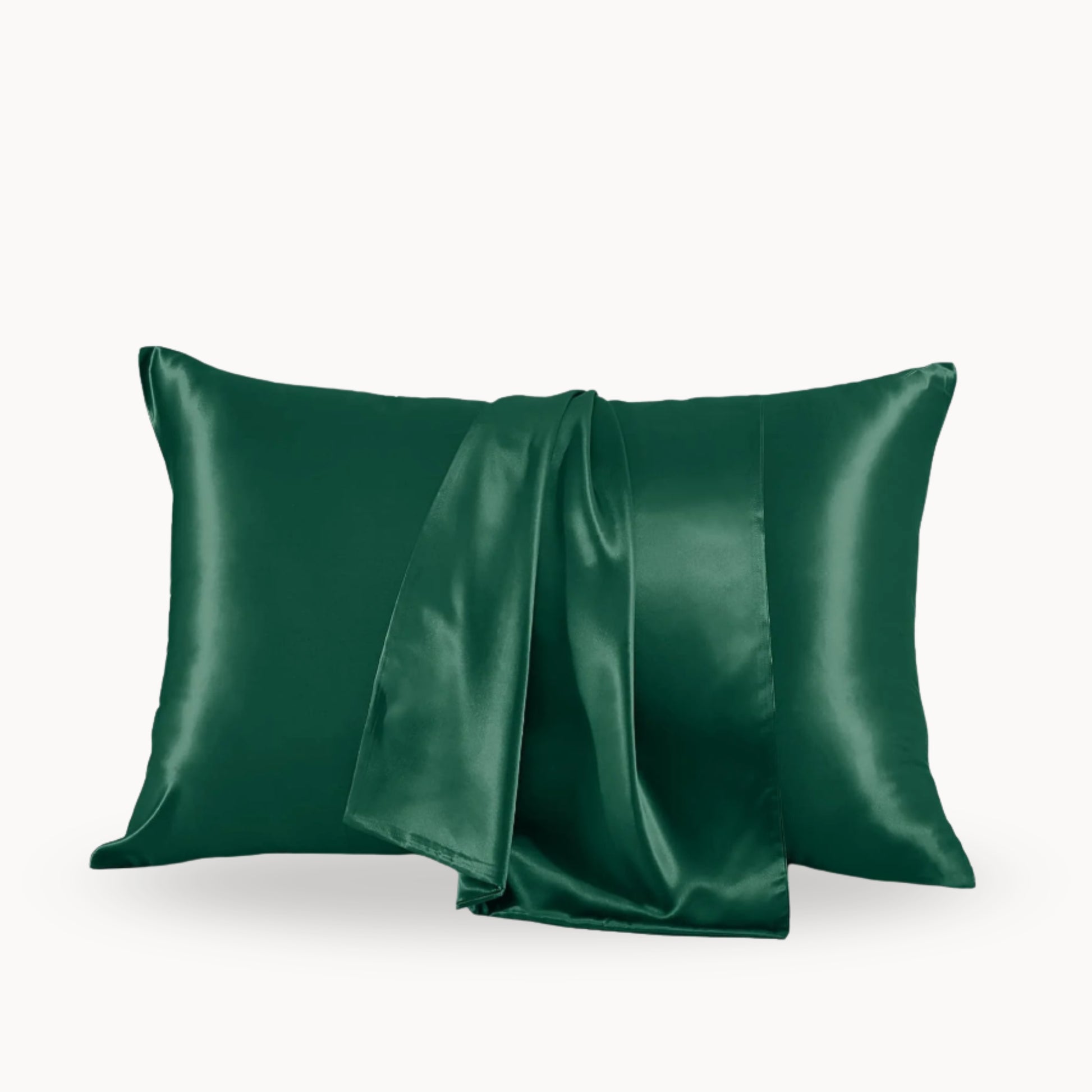 Two green satin pillowcases on a white background
