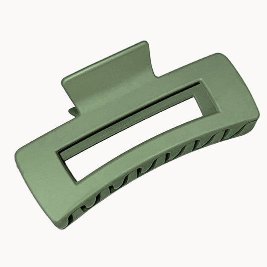 Green plastic clip on a white background