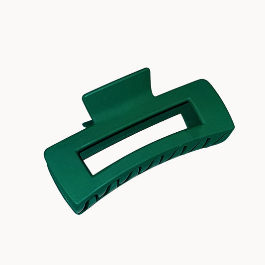 Green plastic clip on a white background