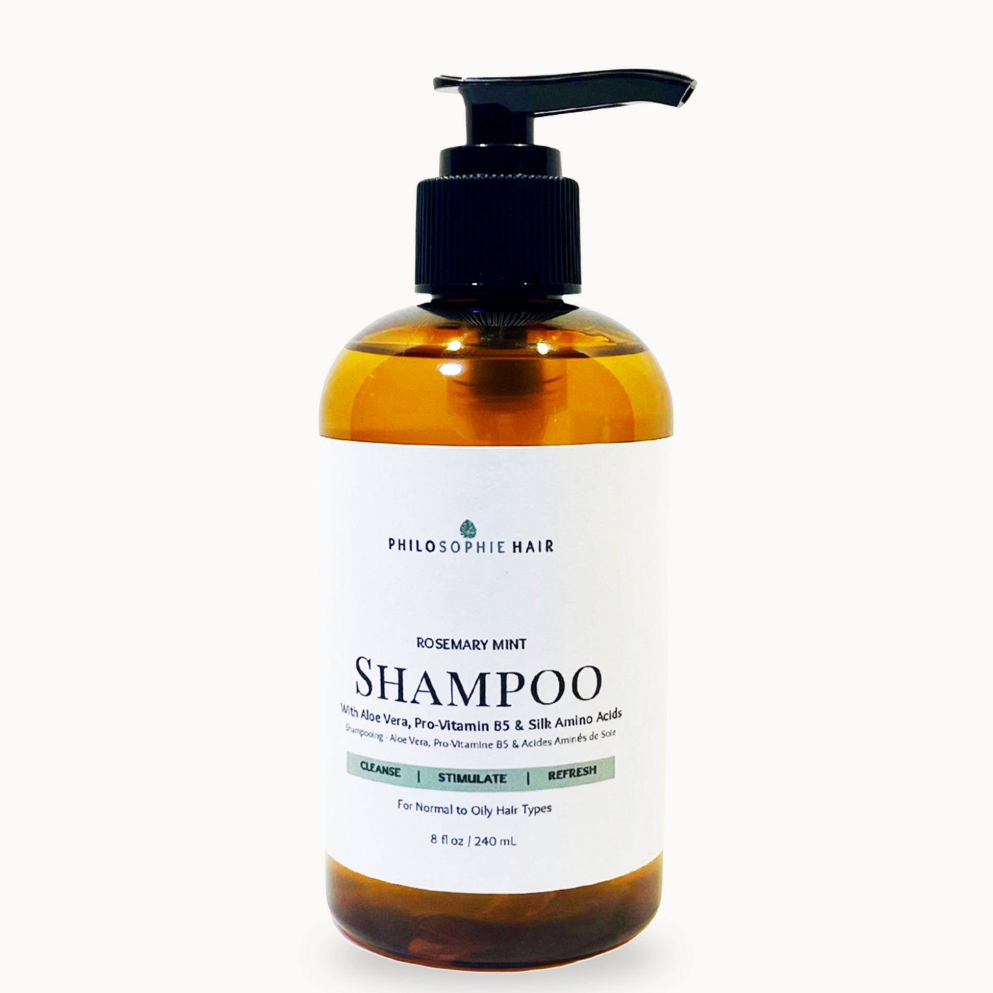 Bottle of Philosophe Hair Shampoo with pump on a white background