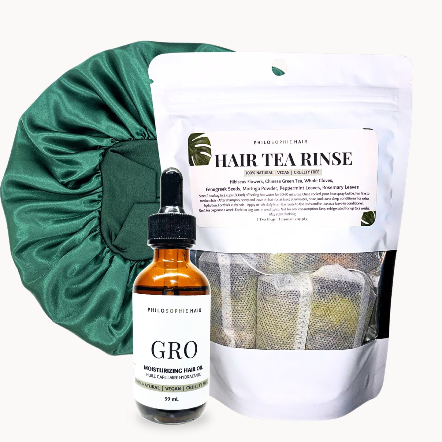 Hair care products including a bottle labeled 'GRO', a hair tea rinse package, and a green satin bonnet on a white background.