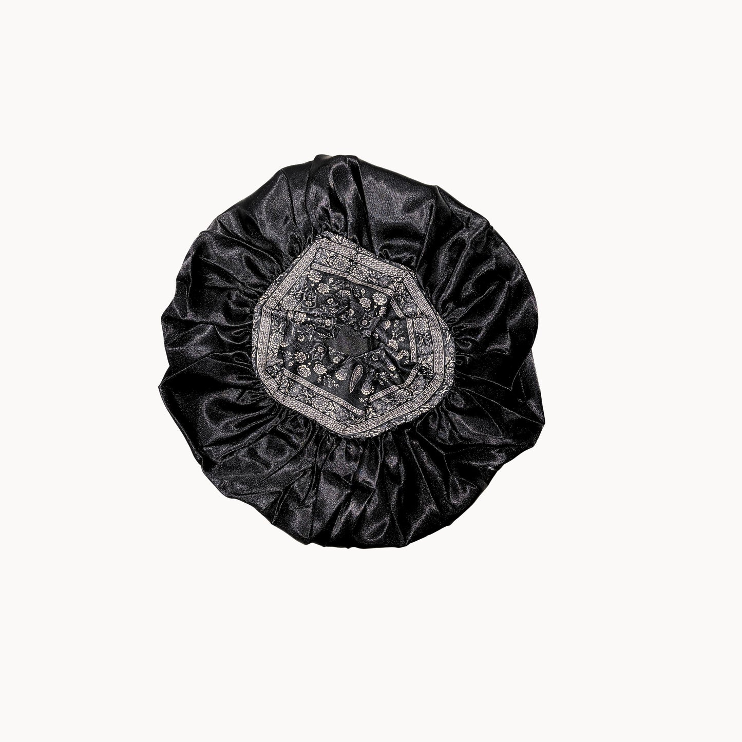 Black satin bonnet with floral embroidery pattern on a white background