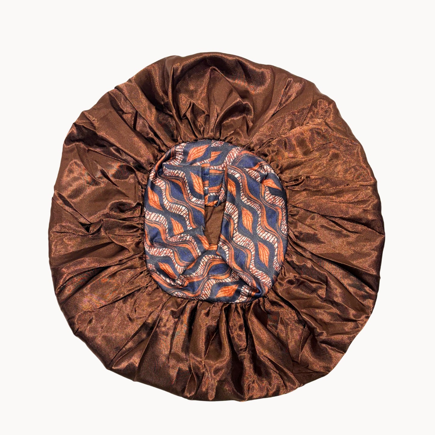 Brown satin bonnet with a patterned band on a white background