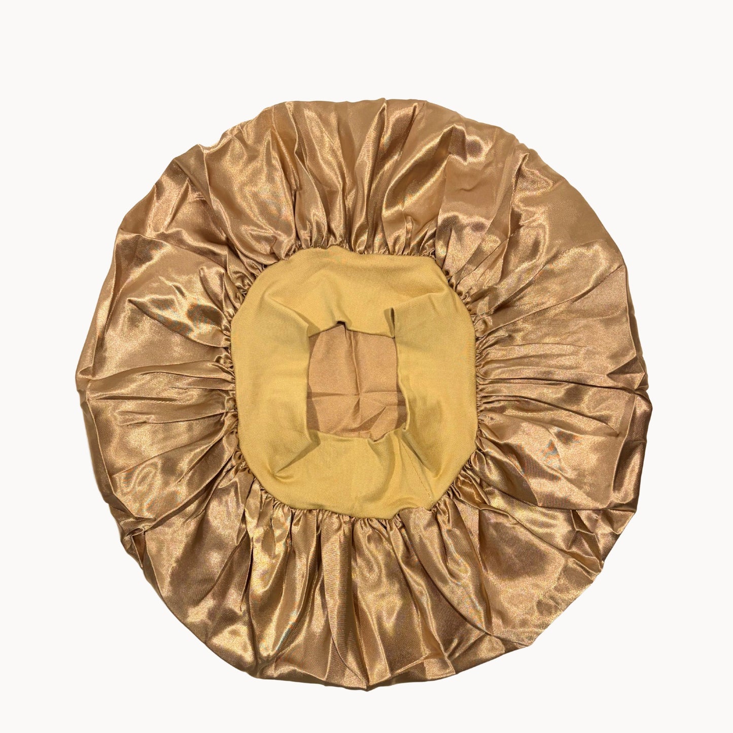 Gold satin hair cap on a white background